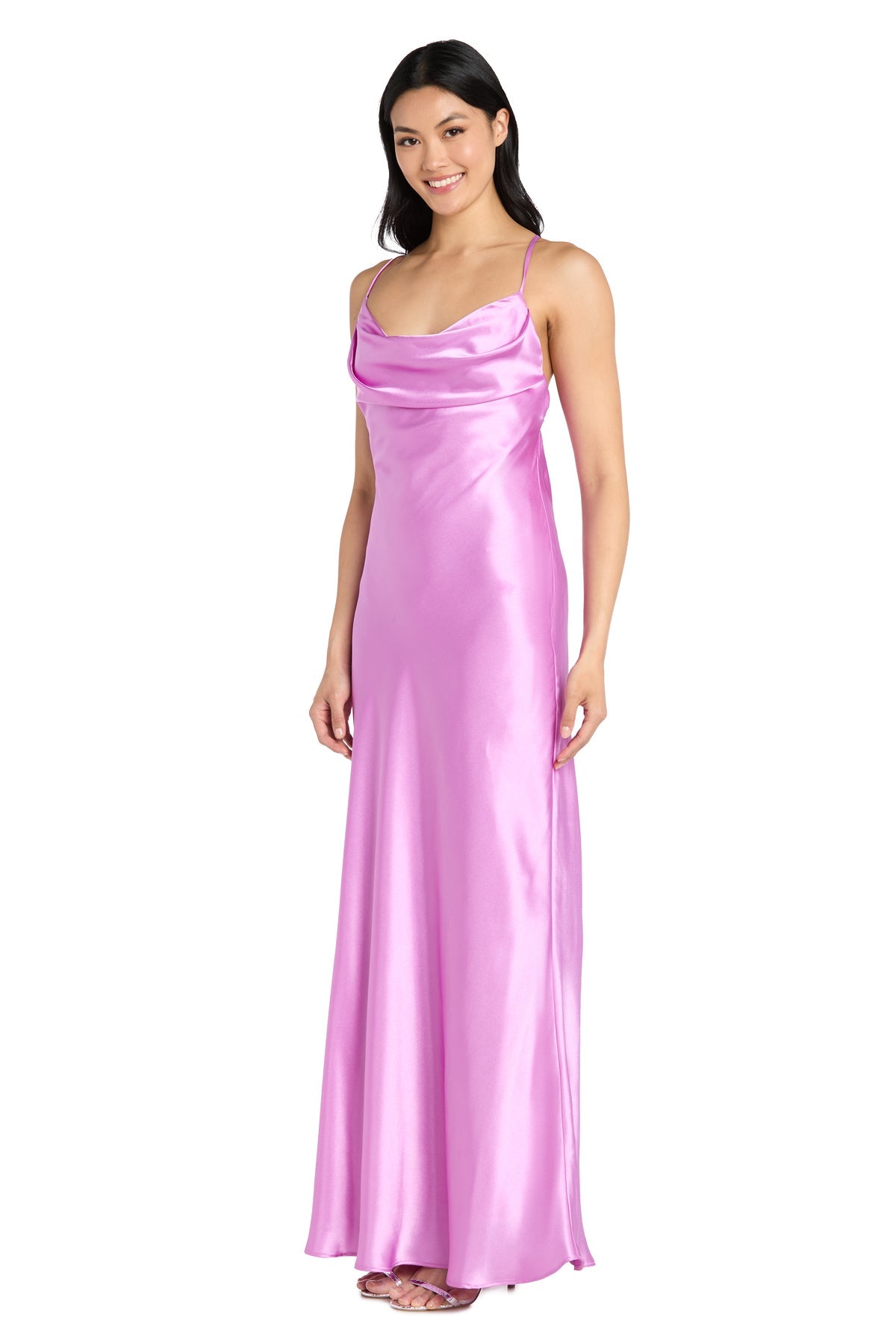 A woman wears the Cowl-Neck Long Satin Prom Dress: Morgan 10037N, a floor-length pink gown with thin straps, a draped neckline, sleeveless design, and an elegant satin silhouette.